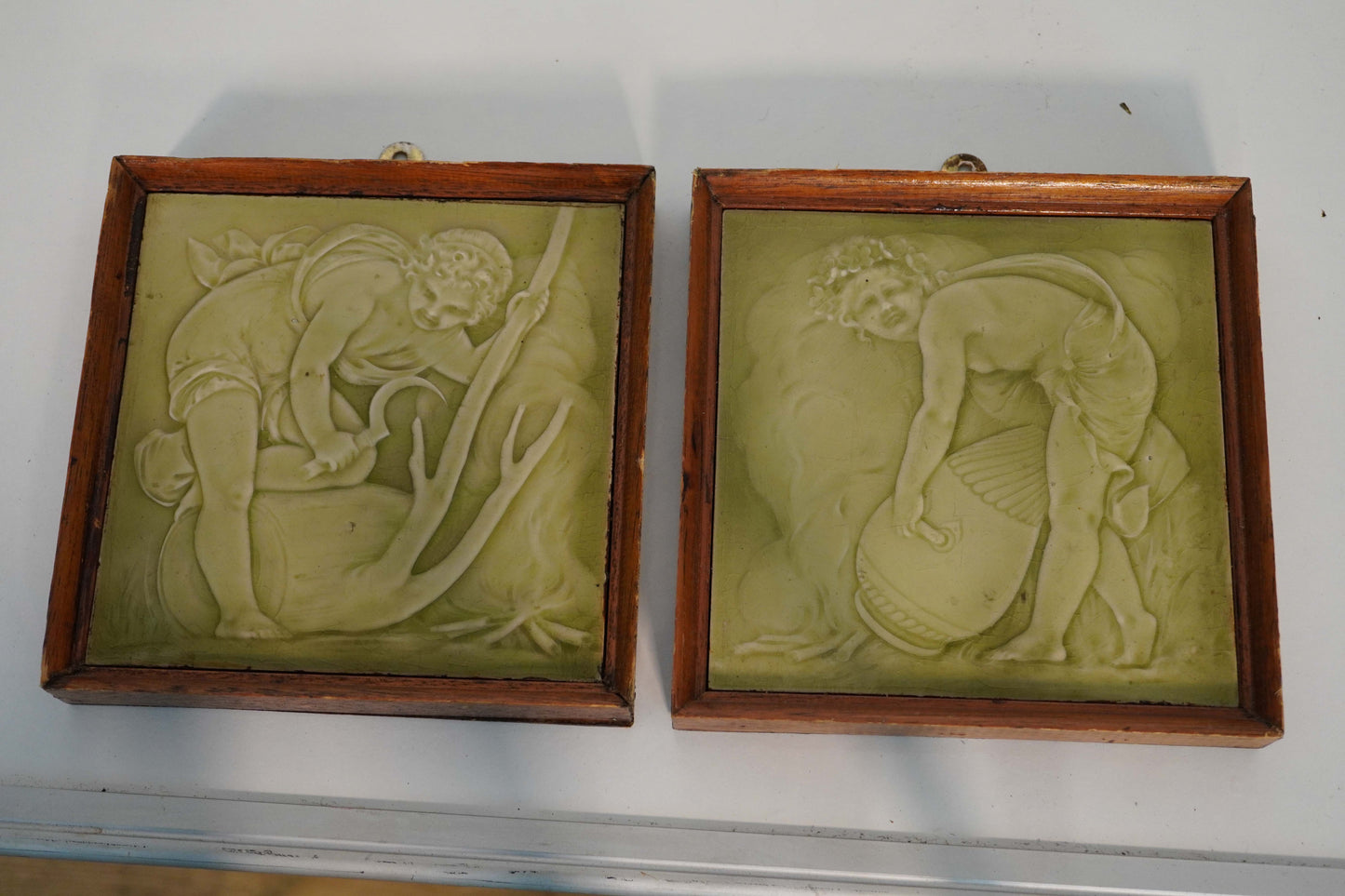 Enamelled Relief Tiles in Wooden Frames - Set of 2 Cherub Scenes