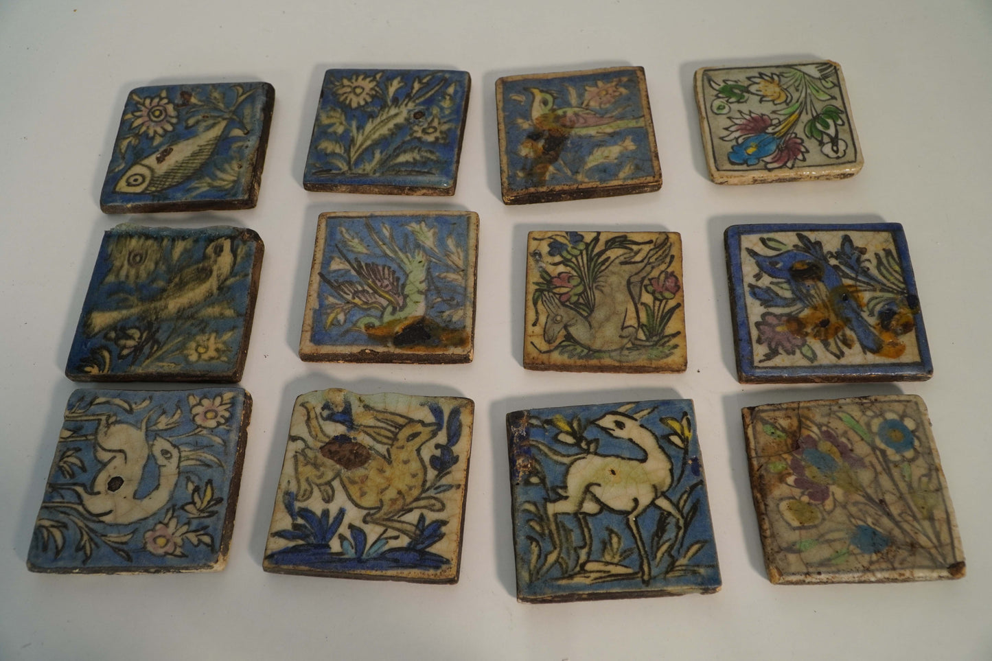 Set of 12 Antique Hand-Painted Persian Ceramic Tiles – Animal and Floral Motifs